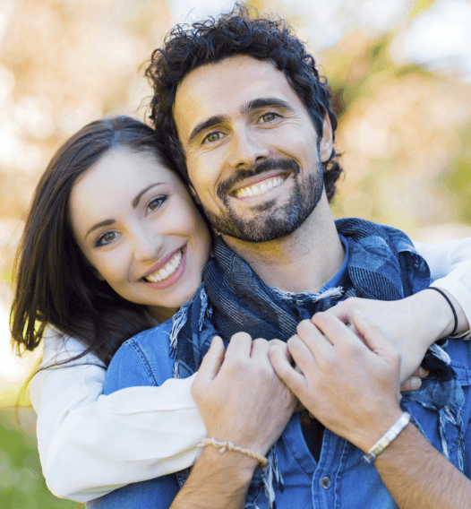 Man and woman smiling after visiting the dentist