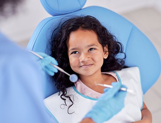 a child having their teeth cleaned by a dentist