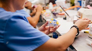 a dental lab technician crafting a partial denture