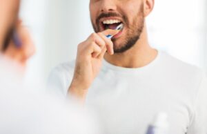 a man brushing his teeth 